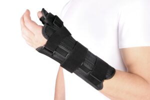 Someone wearing a medical hand strap due to nerve damage in their wrist.